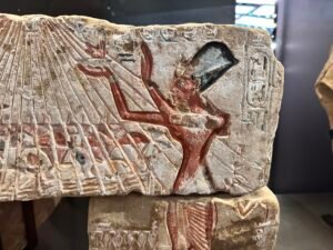 Painted Amarna relief of Akhenaten raising his arms beneath rays of the Aten