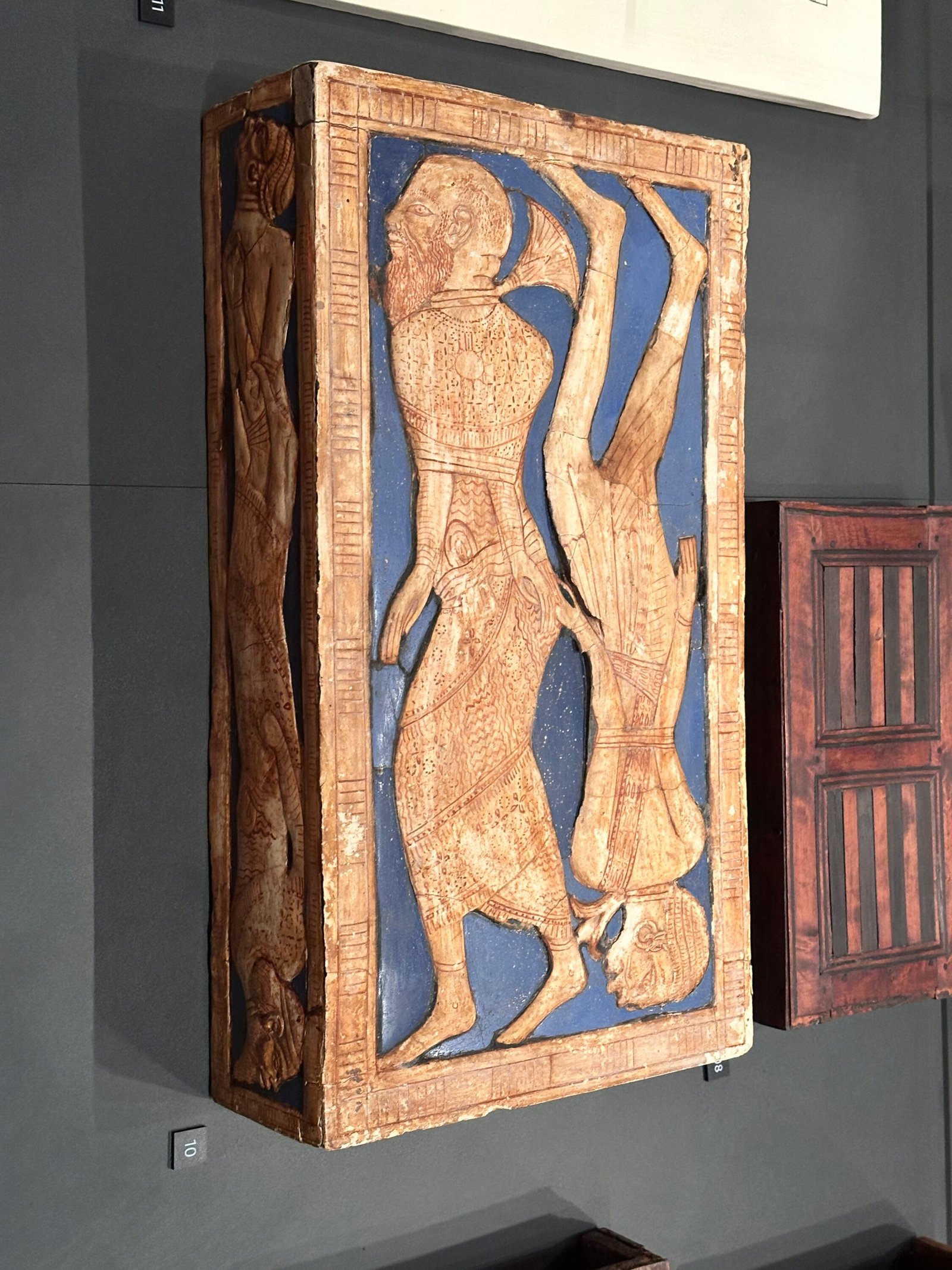 Tutankhamun travelling stool JE 62044 / Carter 511 showing bound Asiatic and Nubian captives against blue faience on the side panel