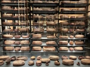 Large display of woven baskets, lidded containers and trays from Tutankhamun’s tomb KV62 in the Tutankhamun Galleries at the Grand Egyptian Museum in Giza