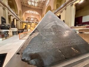 Basalt pyramidion from the pyramid complex of Pharaoh Amenemhat III at Dahshur, with winged sun disk, paired eyes, royal cartouches and hieroglyphic text to Ra, Egyptian Museum in Cairo