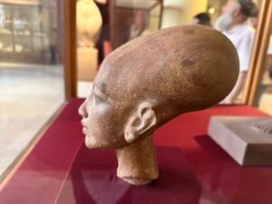 Quartzite head of a daughter of Akhenaten, probably Princess Meritaten, JE 44869, with elongated Amarna-style skull and pierced ear, Egyptian Museum in Cairo