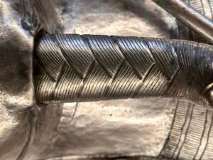Close-up of the long diagonally patterned royal false beard on the silver coffin of Pharaoh Psusennes I, JE 85917, Egyptian Museum in Cairo
