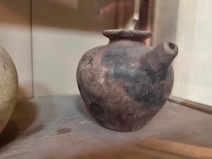 Predynastic Egyptian red-brown pottery jar with a rounded body, broad flared rim and straight shoulder spout, Egyptian Museum in Cairo