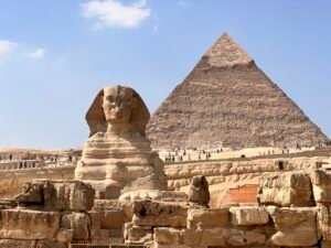 Great Sphinx of Giza in the foreground with the Pyramid of Khafre rising behind it under a blue sky