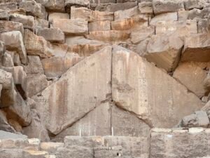 Large angled limestone blocks forming chevron masonry at the Great Pyramid of Khufu on the Giza Plateau