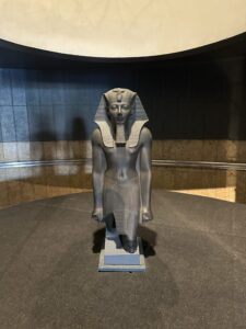 Greywacke striding statue of Pharaoh Thutmose III, Luxor Museum J.2 / CG 42054 / JE 36927, with missing feet, nemes headdress and royal beard