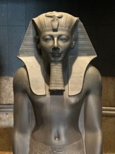 Close-up of Pharaoh Thutmose III on greywacke statue CG 42054 / JE 36927, showing the nemes headdress, uraeus and ceremonial beard at Luxor Museum