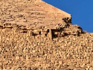 Close view of the Pyramid of Khafre on the Giza Plateau showing surviving smooth casing stones above rougher core masonry