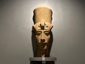 Sandstone head of Pharaoh Akhenaten wearing a tall double crown and uraeus, from his Aten complex at East Karnak and displayed at Luxor Museum