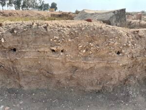 Excavated soil profile with distinct occupation layers, pottery and stone fragments at Tell Basta, ancient Bubastis, in Zagazig in Egypt's eastern Nile Delta