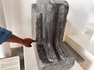 Lower portion of a black granite seated statue of Pharaoh Sobekhotep IV Khaneferre, 13th Dynasty, with royal titulary carved beside the legs at Tanis in Egypt's eastern Nile Delta