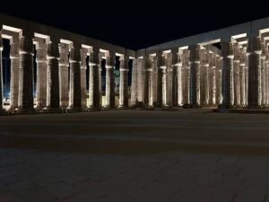 Illuminated papyrus-bundle columns surrounding the peristyle court of Pharaoh Amenhotep III at Luxor Temple in Luxor, Egypt