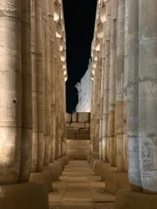 Illuminated side aisle between papyrus-bundle columns in the peristyle court of Pharaoh Amenhotep III at Luxor Temple in Luxor, Egypt