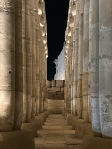 Illuminated side aisle between papyrus-bundle columns in the peristyle court of Pharaoh Amenhotep III at Luxor Temple in Luxor, Egypt