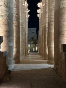 Illuminated passage between the colossal columns of Amenhotep III's Great Colonnade at Luxor Temple, built as the processional axis for the Opet Festival in Luxor, Egypt