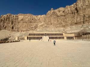 Wide view of Hatshepsut's mortuary temple Djeser-Djeseru beneath the steep limestone cliffs at Deir el-Bahari on Luxor's west bank