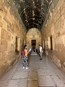 Vaulted Main Sanctuary of Amun-Re inside Hatshepsut's mortuary temple at Deir el-Bahari, with dark blue star ceiling, painted reliefs and Osiride royal statues
