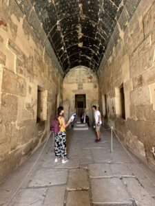 Vaulted Main Sanctuary of Amun-Re inside Hatshepsut's mortuary temple at Deir el-Bahari, with dark blue star ceiling, painted reliefs and Osiride royal statues