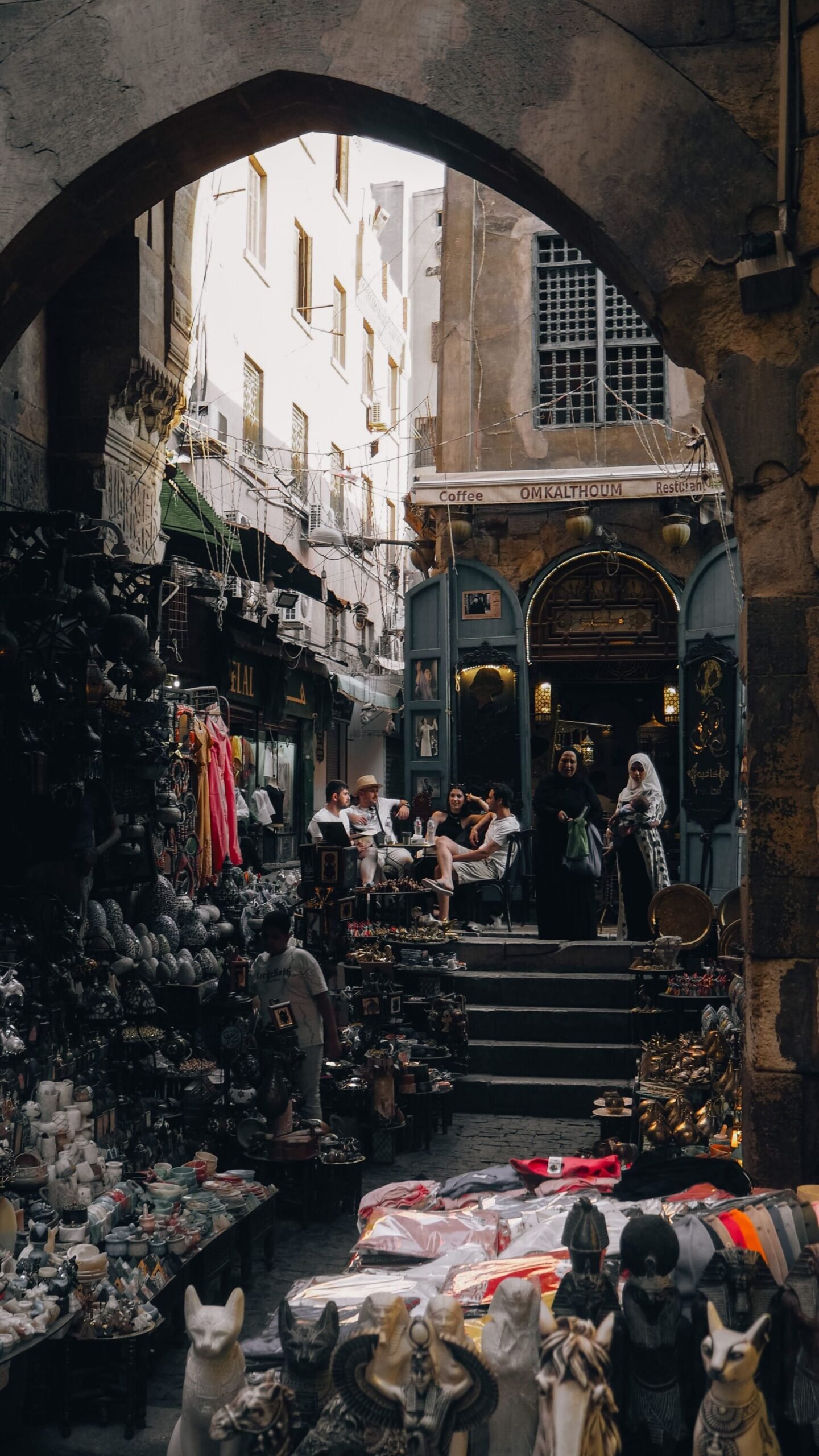 Narrow market lane filled with souvenir stalls and shoppers in Khan el-Khalili bazaar in Cairo, Egypt